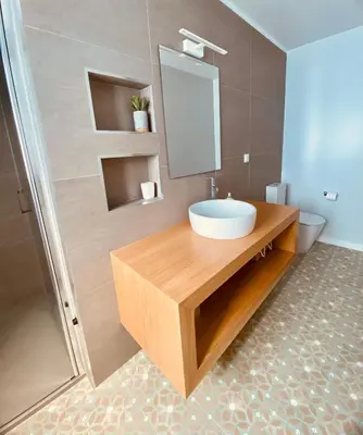 a bathroom with a sink and a mirror at Casa Victória in Funchal