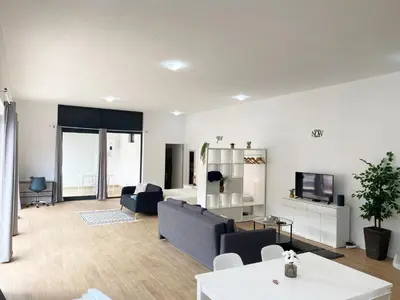 a living room with a couch and a tv at Machico flat center near beach w parking in Machico