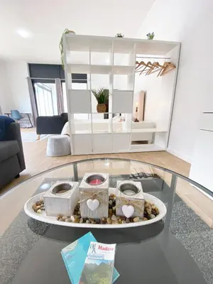 a glass table with baskets on top of a room at Machico flat center near beach w parking in Machico