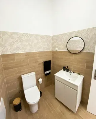 a bathroom with a toilet and a sink at Machico flat center near beach w parking in Machico