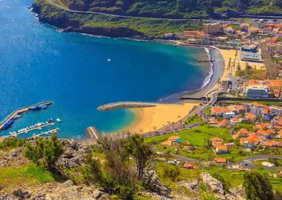 an aerial view of a beach and the ocean at Machico flat center near beach w parking in Machico