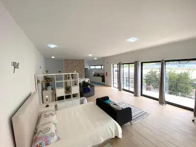 a bedroom with a bed and a living room at Machico flat center near beach w parking in Machico