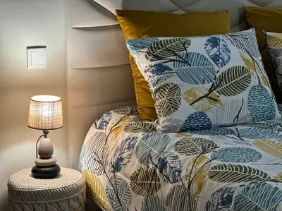 a bedroom with a bed with a pillow and a lamp at Bem Me Quer in Caniço