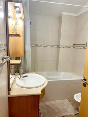 a bathroom with a sink and a bath tub at Villa Abreu in Ponta do Sol