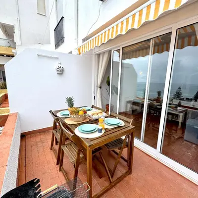a living room with a blue couch and a view of the ocean at Luz Ocean View Apartment in Luz