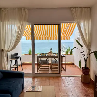 a bedroom with a large white bed with two lamps at Luz Ocean View Apartment in Luz
