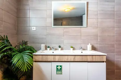 a bathroom with a sink and a mirror at Thomas Suite Calheta in Lombada dos Marinheiros