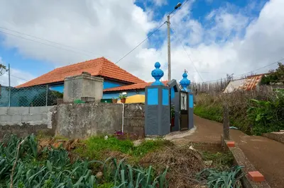 a house with a blue gate in front of it at Thomas Suite Calheta in Lombada dos Marinheiros