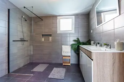 a bathroom with a sink and a shower at Thomas Suite Calheta in Lombada dos Marinheiros