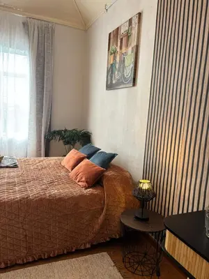 a bedroom with a bed with orange pillows on it at Thomas Suite Calheta in Lombada dos Marinheiros