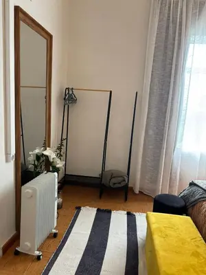 a living room with a radiator and a window at Thomas Suite Calheta in Lombada dos Marinheiros