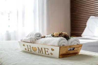 a wooden box with towels and a welcome sign on a bed at Thomas Suite Calheta in Lombada dos Marinheiros