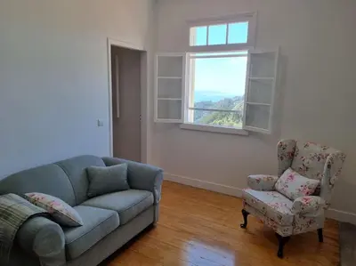 a living room with a couch and a chair and a window at Quiet Countryside Nature Retreat in Santa Cruz