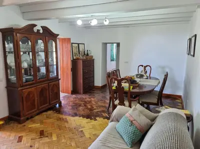 a living room with a couch and a table at Quiet Countryside Nature Retreat in Santa Cruz