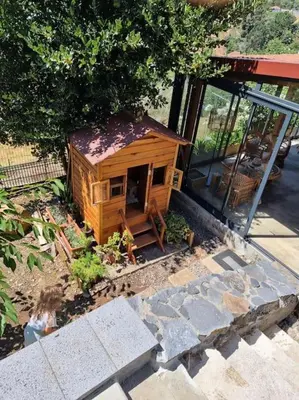 a small wooden house sitting outside of a building at Quiet Countryside Nature Retreat in Santa Cruz