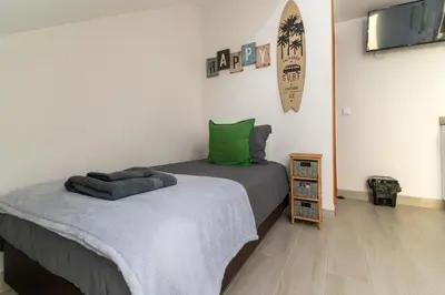 a bedroom with a bed and a flat screen tv at Villas Renacer in Paul do Mar