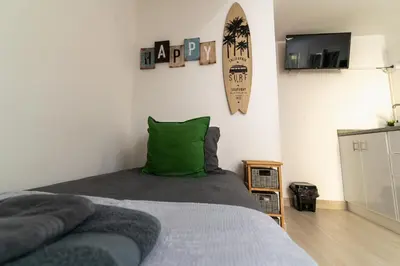 a bedroom with a bed with a green pillow at Villas Renacer in Paul do Mar