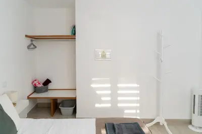 a bedroom with a desk and a white wall at Villas Renacer in Paul do Mar