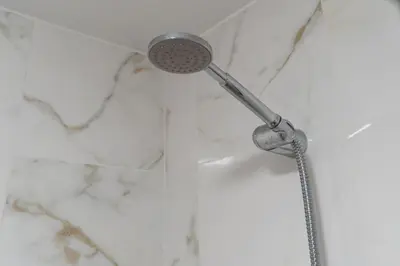 a shower with a shower head in a bathroom at Villas Renacer in Paul do Mar