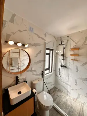 a bathroom with a toilet and a sink and a mirror at Casa da Ribeira in Vila do Bispo