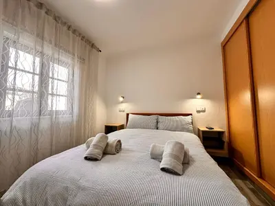 a bedroom with a bed with towels on it at Casa da Ribeira in Vila do Bispo