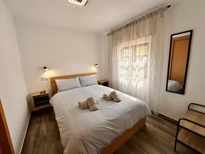 a bedroom with a bed with two towels on it at Casa da Ribeira in Vila do Bispo