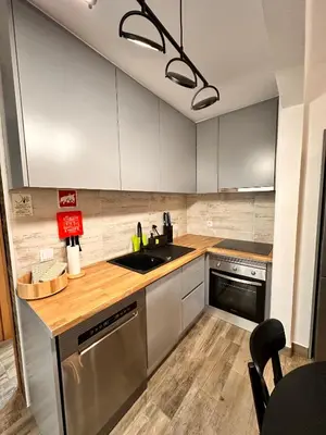 a kitchen with white cabinets and a sink at Casa da Ribeira in Vila do Bispo