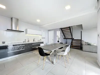a kitchen and dining room with a table and chairs at Gertrudes Dream House in Ponta do Sol