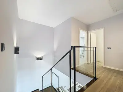 a staircase in a house with a glass railing at Gertrudes Dream House in Ponta do Sol