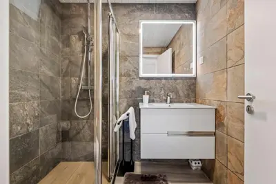 a bathroom with a sink and a shower at Calheta Sunsets in Estreito da Calheta