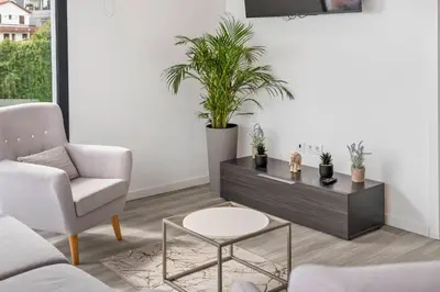 a living room with a couch and a table with plants at Calheta Sunsets in Estreito da Calheta