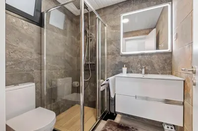a bathroom with a shower and a toilet and a sink at Calheta Sunsets in Estreito da Calheta