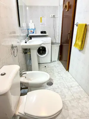 a bathroom with a toilet sink and a washing machine at Holidays Madeira in São Vicente