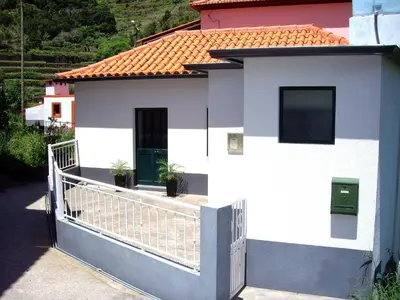 a white house with a gate and a fence at Holidays Madeira in São Vicente