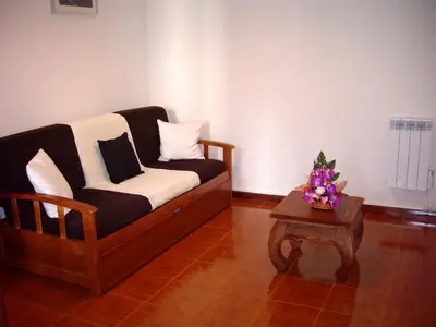 a living room with a couch and a table at Holidays Madeira in São Vicente