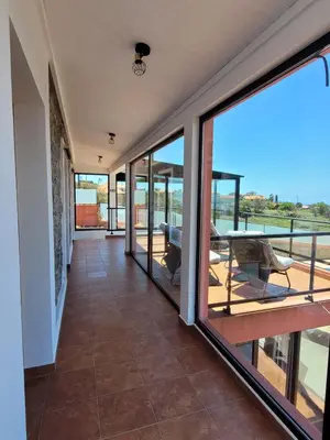 a house with a view of the ocean at Sunset Paradise Villa with Heated Pool in Calheta