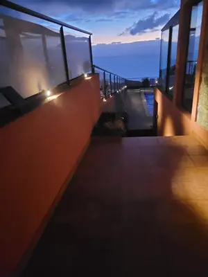a balcony with lights on the side of a building at Sunset Paradise Villa with Heated Pool in Calheta