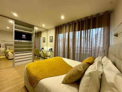 a bedroom with a bed with a yellow blanket on it at Living Funchal V in Funchal