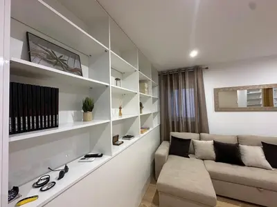 a living room with a couch and shelves at Living Funchal V in Funchal