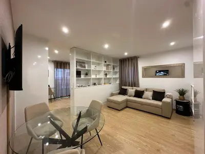 a living room with a glass table and a couch at Living Funchal V in Funchal