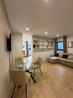 a living room with a glass table and chairs at Living Funchal V in Funchal