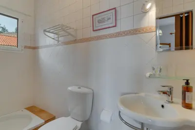 a white bathroom with a toilet and a sink at Sa Dias House by AH in São Jorge