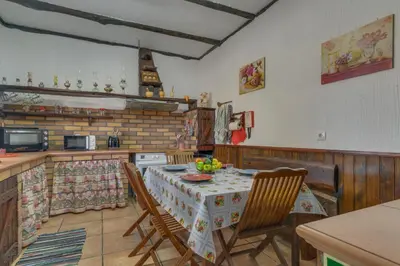 a kitchen with a table and chairs in a kitchen at Sa Dias House by AH in São Jorge