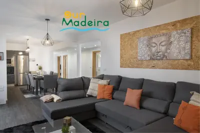 a living room with a couch and a dining room at OurMadeira - VistaSerena in Raposeira do Logarinho