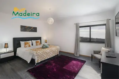 a bedroom with a bed and a purple rug at OurMadeira - VistaSerena in Raposeira do Logarinho