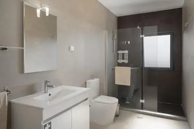 a bathroom with a sink and a toilet and a shower at OurMadeira - VistaSerena in Raposeira do Logarinho