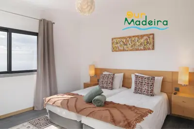a bedroom with a bed and a window at OurMadeira - VistaSerena in Raposeira do Logarinho