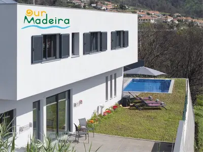 a white building with a patio and a swimming pool at OurMadeira - VistaSerena in Raposeira do Logarinho