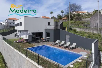 a villa with a swimming pool and a house at OurMadeira - VistaSerena in Raposeira do Logarinho