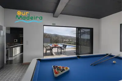 a pool table in a room with a kitchen at OurMadeira - VistaSerena in Raposeira do Logarinho